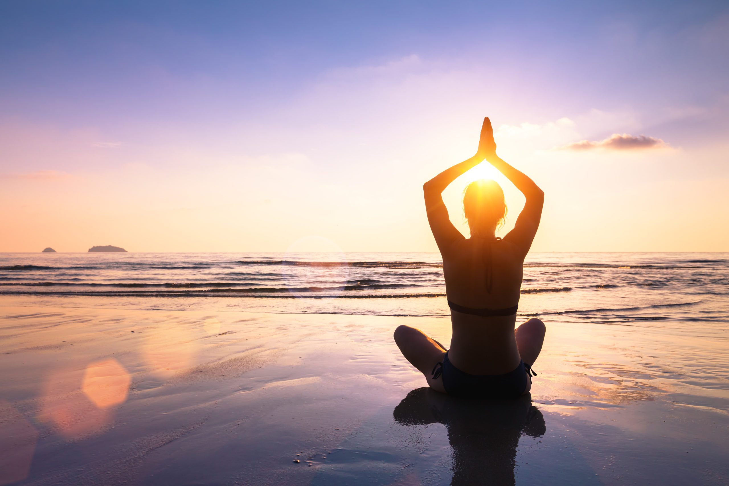Yoga and meditation calm peaceful beach sunset fit young woman Ergo21
